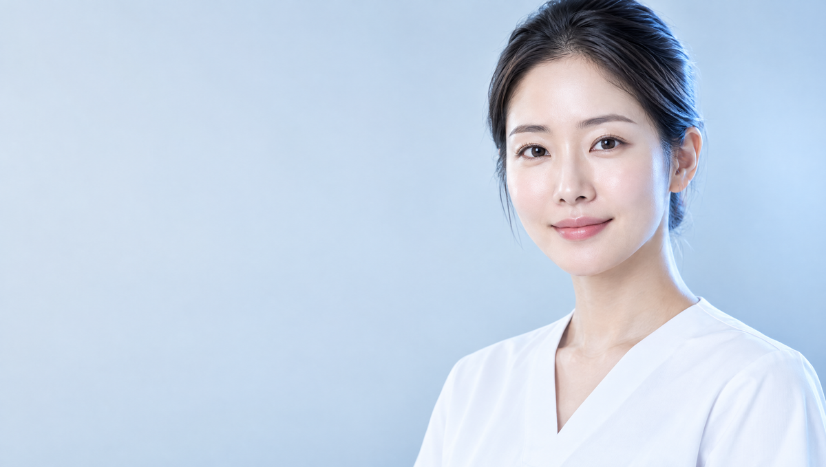 Clinician with clear skin against a light blue studio background